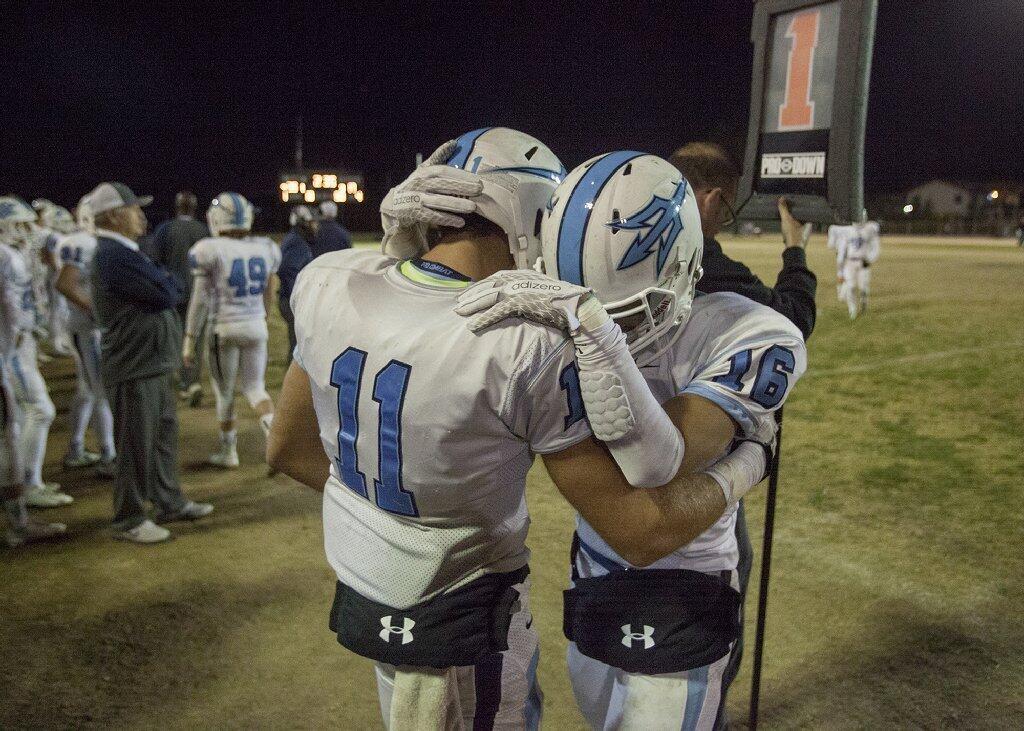 Corona del Mar's Dylan Tucker, left, consoles Reece Perez after losing to Buena Park in a CIF Southern Section Southwest Division quarterfinal game.