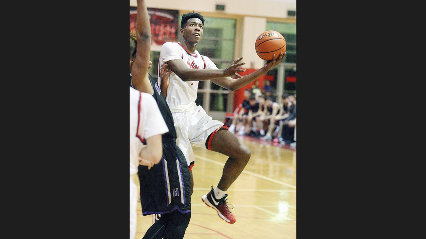 Burroughs' Tristen Hull gets to the side to take a shot against Hoover in a Pacific League boys' basketball game at Burroughs High School on Wednesday, January 11, 2017.