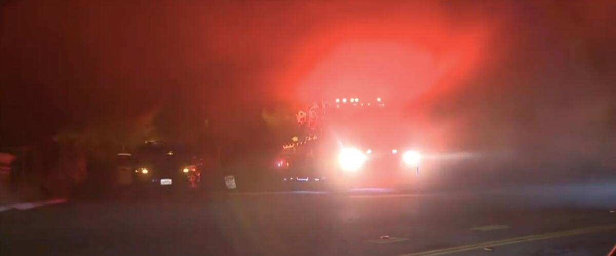 Emergency vehicles in the fog at night