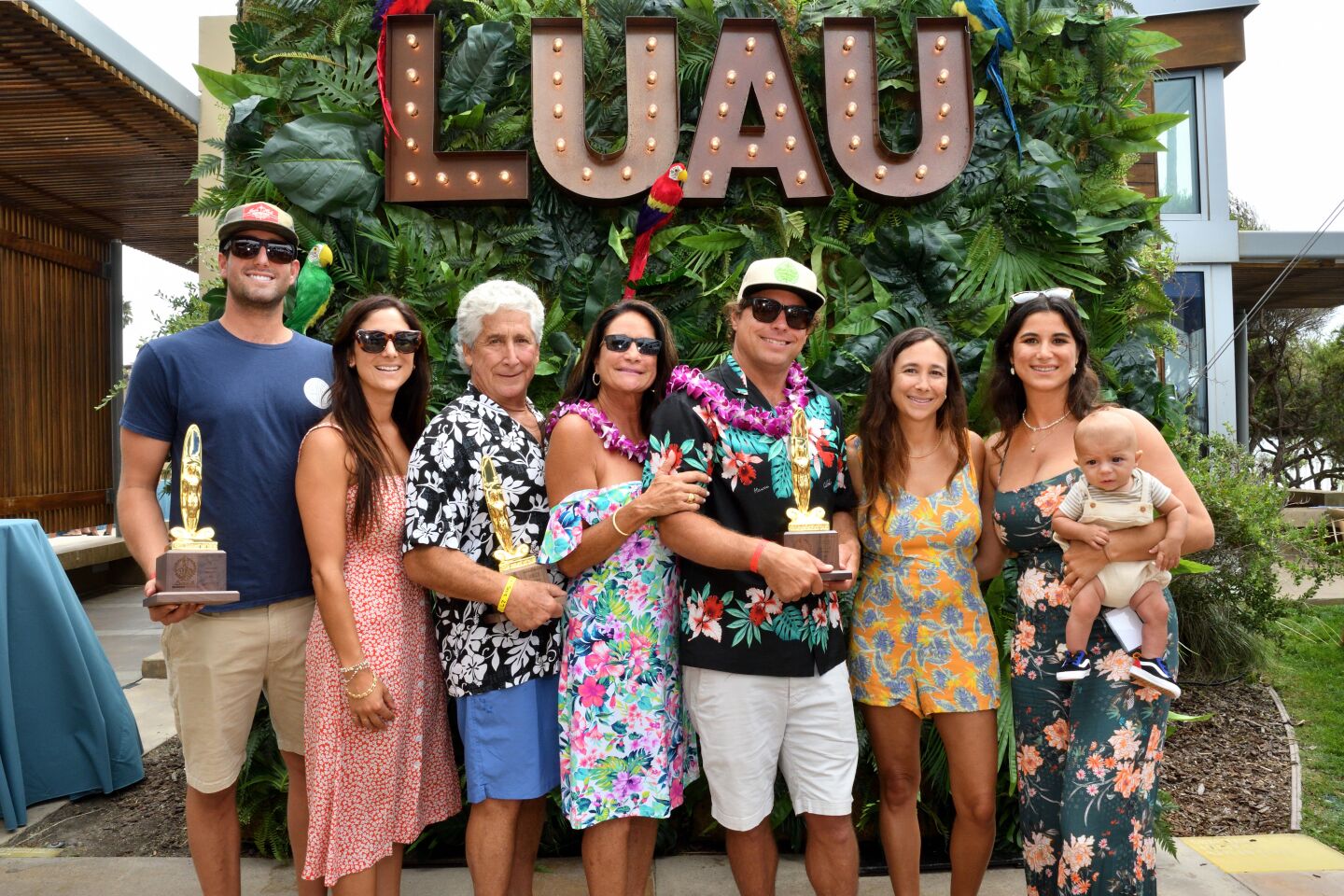 Mason and Allie Derieux, Fred and Nancy Borrelli, Josh and Torie Hall, Bettina Borrelli and baby Cardon Hall show their island style at the Luau & Legends of Surfing Invitational on Aug. 21.