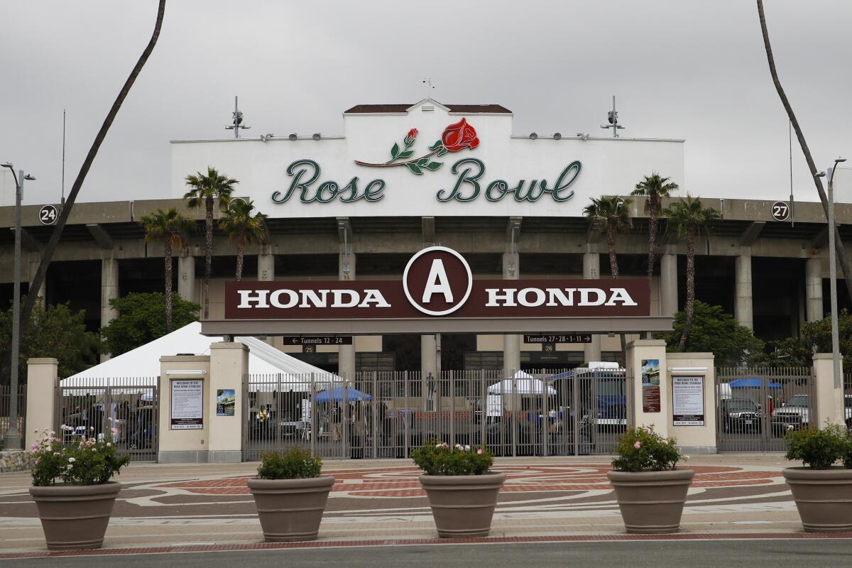 Members of the media gather outside the Rose Bowl Stadium in Pasadena.