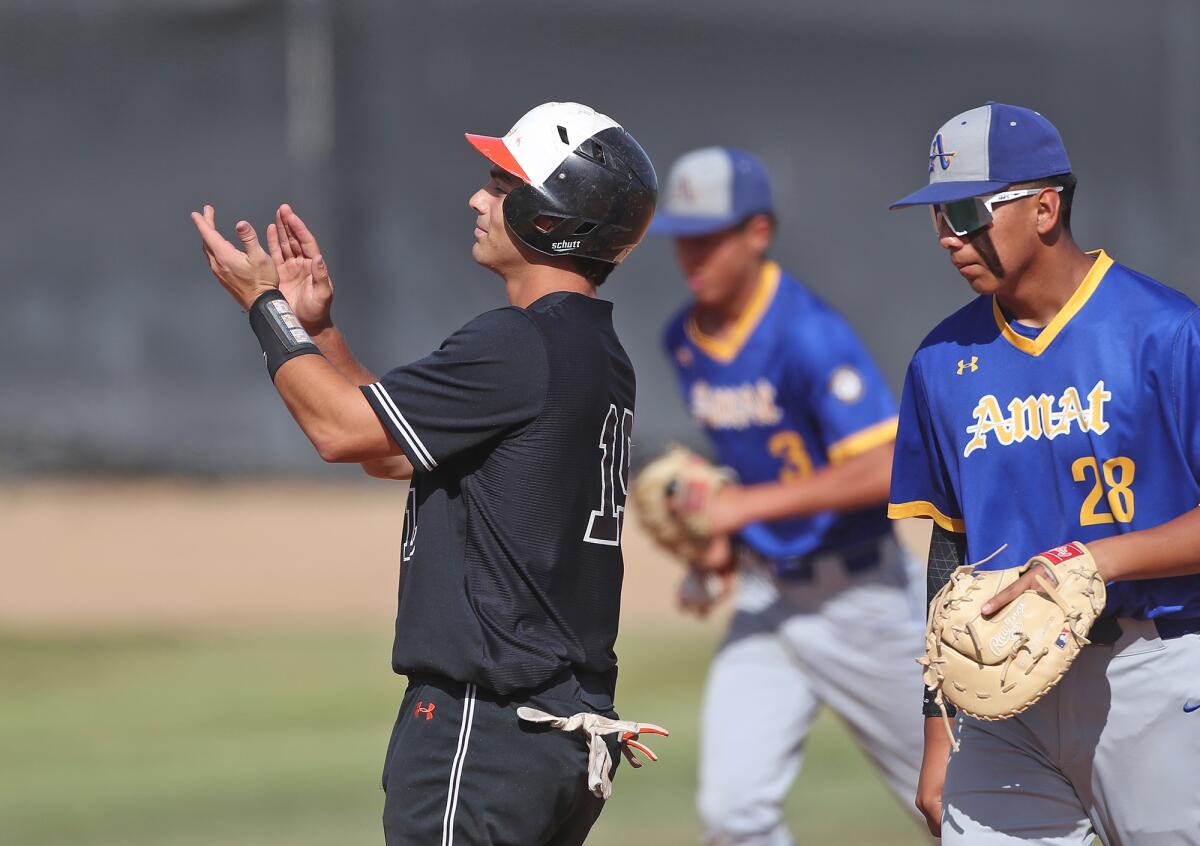 Antonio Ventimiglia of Huntington Beach claps toward his dugout after hitting a double against Bishop Amat on Tuesday.