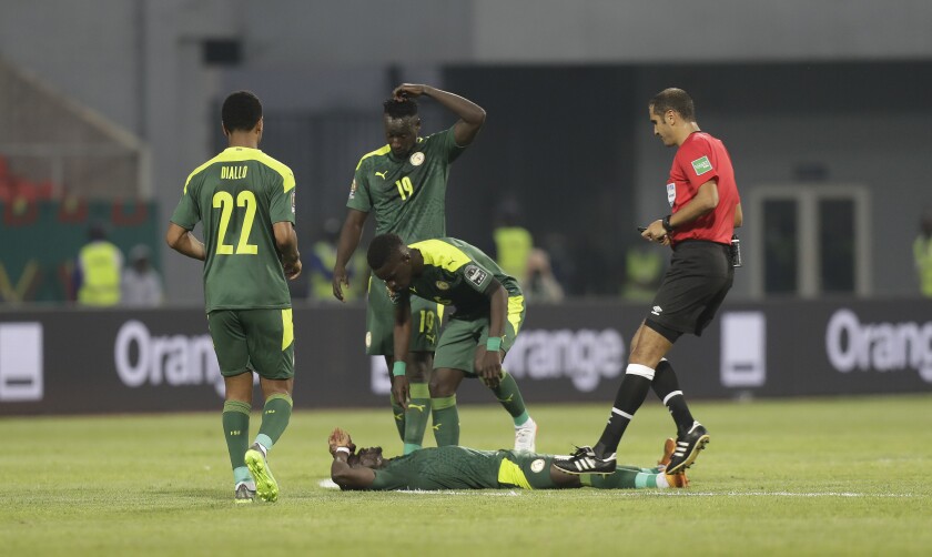 Senegal's Saido Mane lays on the pitch following a collision during the African Cup of Nations 2022 round of 16 match between Senegal and Cape Verde at Kouekong Stadium, Bafoussam, Cameroon, Tuesday, Jan. 25, 2022. (AP Photo/Sunday Alamba)