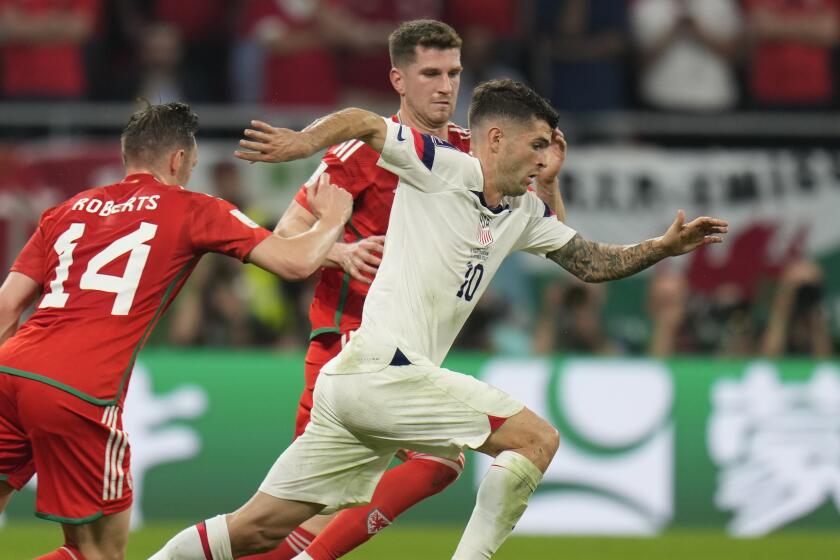 Christian Pulisic of the United States in action in front of Wales' Connor Roberts during the World Cup.
