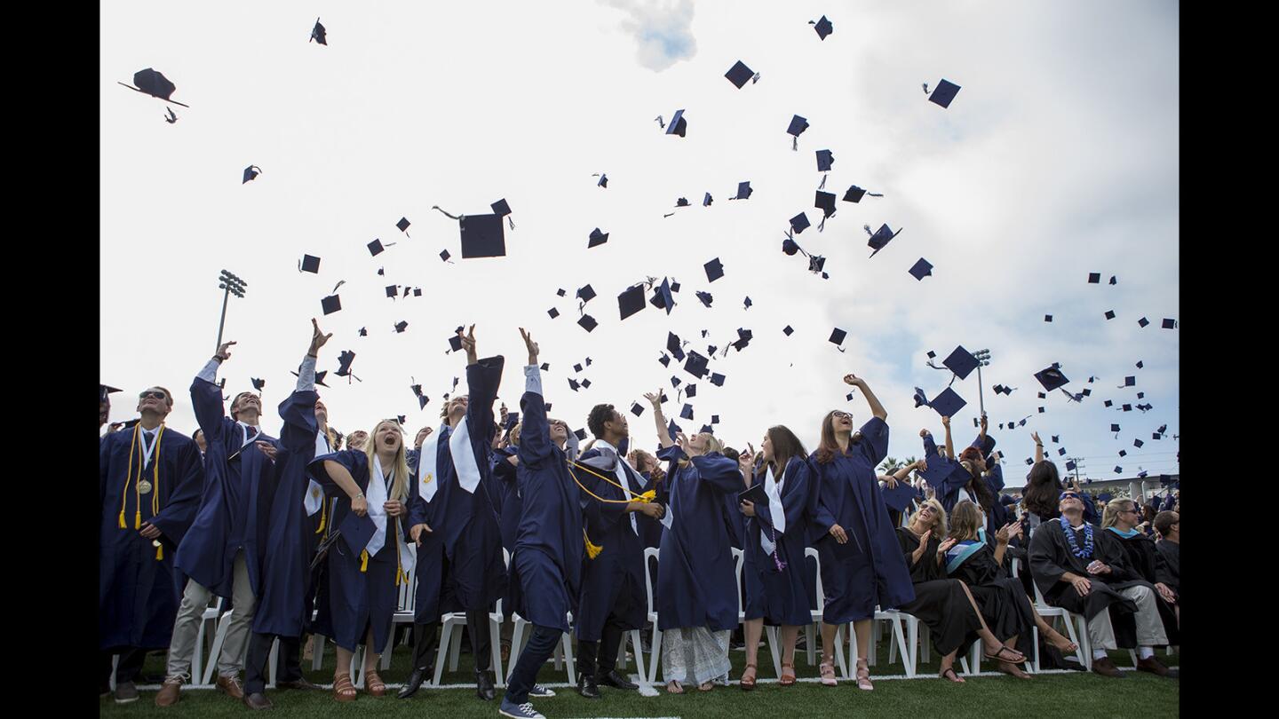 Graduates toss their caps during the Newport Harbor High School 2017 commencement at Davidson Field on Thursday, June 22.