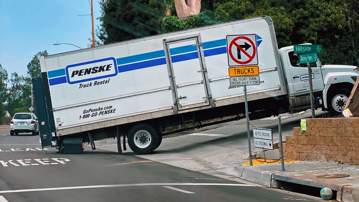 Yet Another Stuck Truck — La Jolla Light reader Carl Doughty supplies this photo and writes: "Despite flashing warnings and signs along both lanes of Torrey Pines Road advising truck drivers not to attempt turning onto Hillside Drive, this truck was spotted the morning of Nov. 11, 2019 doing just that."