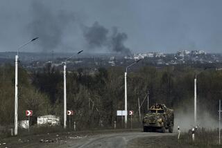 A Ukrainian APC seen on the road on the frontline in Bakhmut, Donetsk region, Ukraine, Sunday, April 9, 2023. (AP Photo/Libkos)