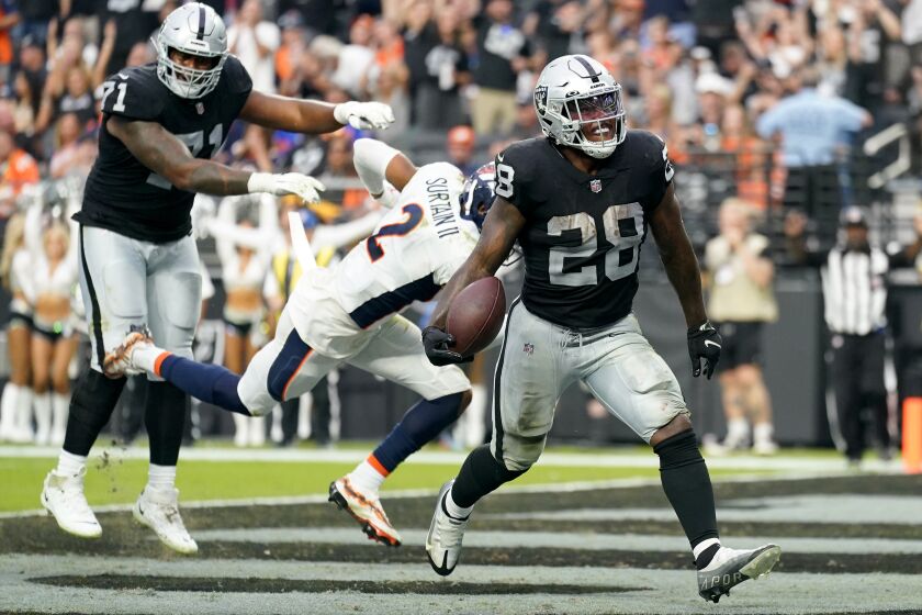 Las Vegas Raiders running back Josh Jacobs (28) scores a touchdown against the Denver Broncos during the second half of an NFL football game, Sunday, Oct. 2, 2022, in Las Vegas. (AP Photo/Abbie Parr)