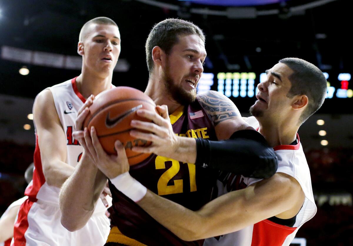 Arizona guard Gabe York tries to steal the ball from Arizona State forward Eric Jacobsen (21) in the first half of their game Sunday in Tucson.
