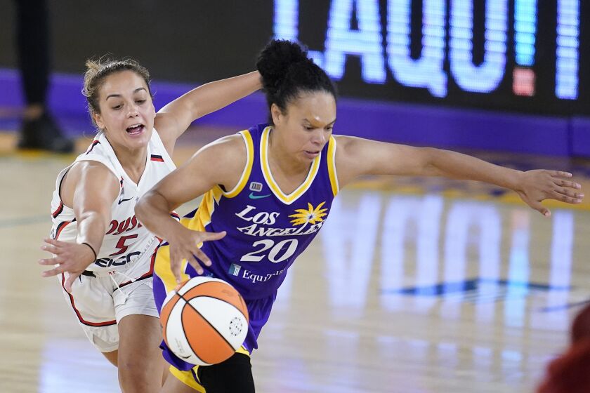 Los Angeles Sparks guard Kristi Toliver, right, dribbles past Washington Mystics guard Leilani Mitchell during the second half of a WNBA basketball game Thursday, June 24, 2021, in Los Angeles.(AP Photo/Marcio Jose Sanchez)