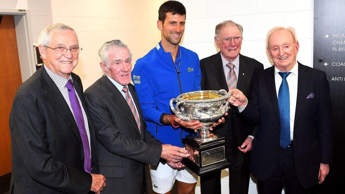 Novak Djokovic, center, stands with Roy Emerson, left, Ken Rosewall, Frank Sedgman and Rod Laver after winning the 2019 Australian Open.
