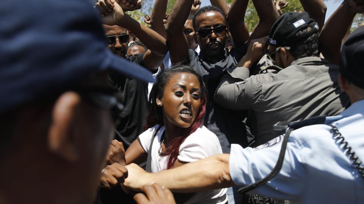Security forces surround Israelis of Ethiopian origin protesting outside the Knesset in Jerusalem on July 15 following the death of a young man of Ethiopian origin who was killed by an off-duty police officer near the Israeli city of Haifa on June 30.