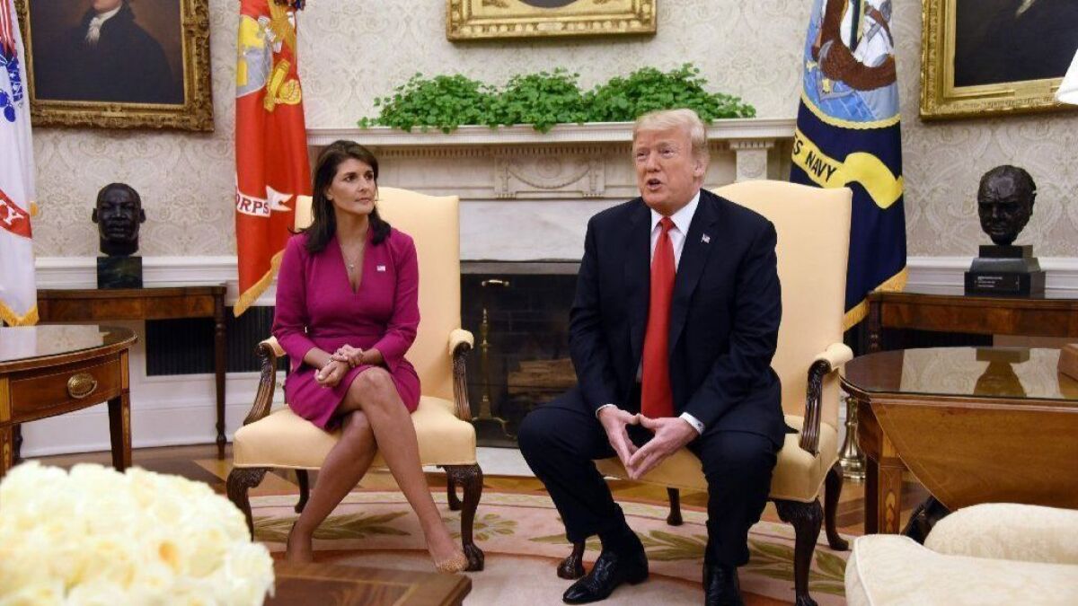 Nikki Haley, outgoing U.S. ambassador to the United Nations, and President Trump appear in the White House Oval Office on Tuesday.