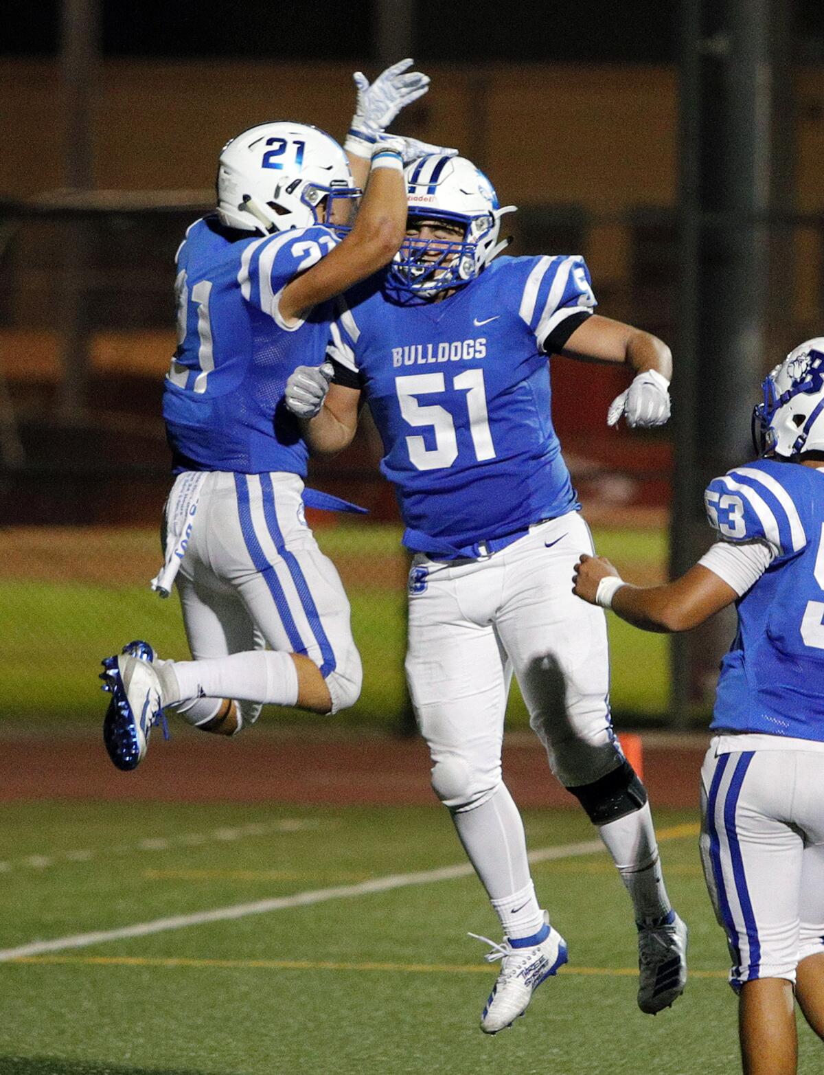 Burbank's Tyler Murphy celebrates a touchdown he scored against Pasadena with Burbank's Danny Akopyan in a Pacific League football game at Memorial Field in Burbank on Tuesday, September 26, 2019.