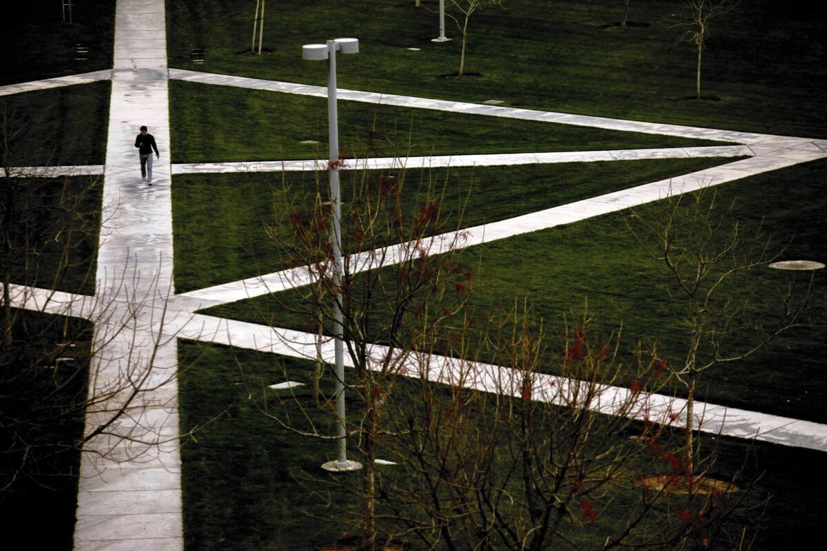 A lone student makes his way through the quad area on the UC Merced campus.