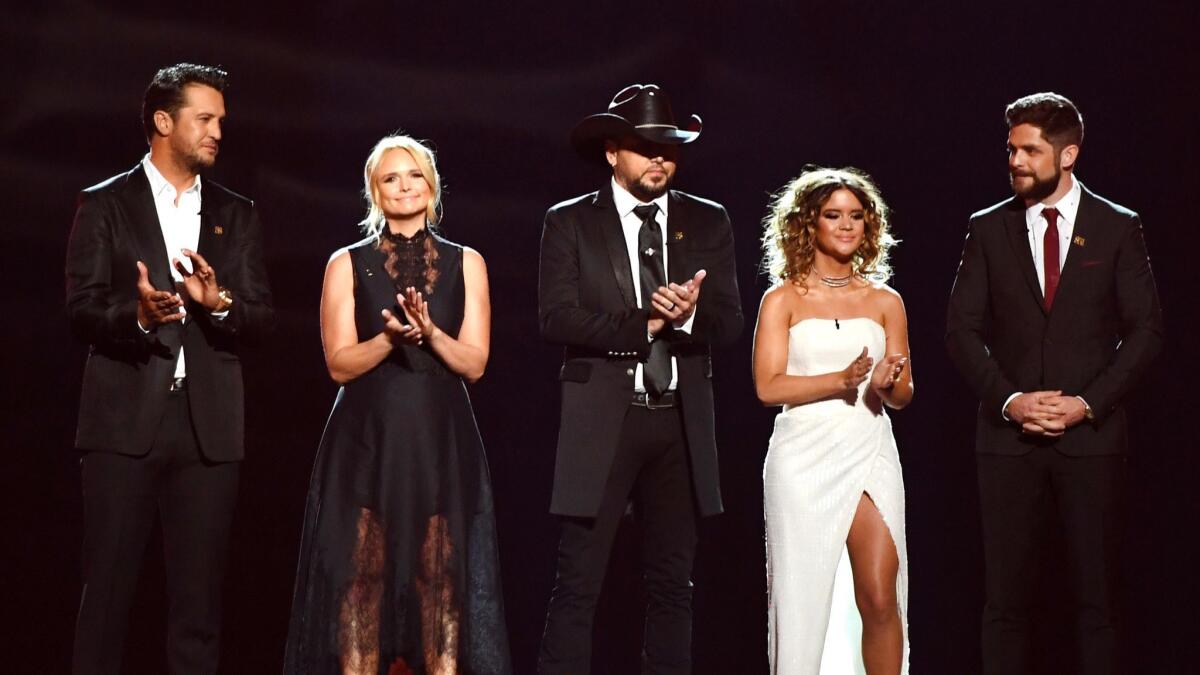 Luke Bryan, left, Miranda Lambert, Jason Aldean, Maren Morris, and Thomas Rhett give a tribute to the Las Vegas shooting victims at Sunday night's ACM Awards.