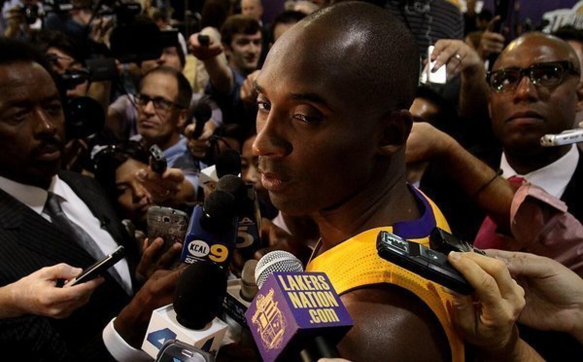 Kobe Bryant, shown at the Lakers' media day Saturday in El Segundo, is recovering from a torn Achilles' tendon.