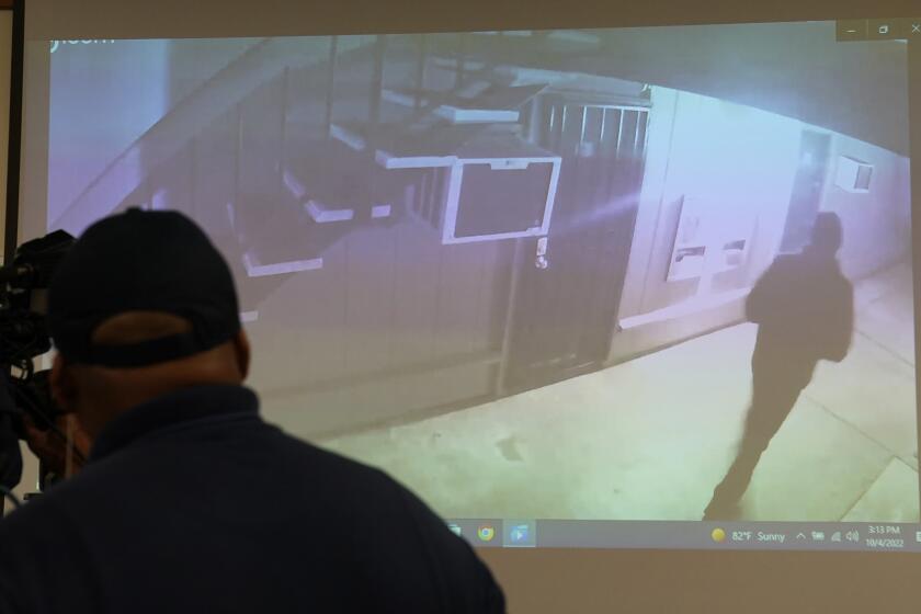 Stockton Police show a a brief video from a surveillance camera of an image of what authorities describe as a "person of interest," in the investigation into a suspected serial killer during a news conference in Stockton, Calif., Tuesday, Oct. 4, 2022. Ballistics tests have linked the fatal shootings of six men and the wounding of one woman in California — all potentially at the hands of a serial killer — in crimes going back more than a year, police said. (AP Photo/Rich Pedroncelli)