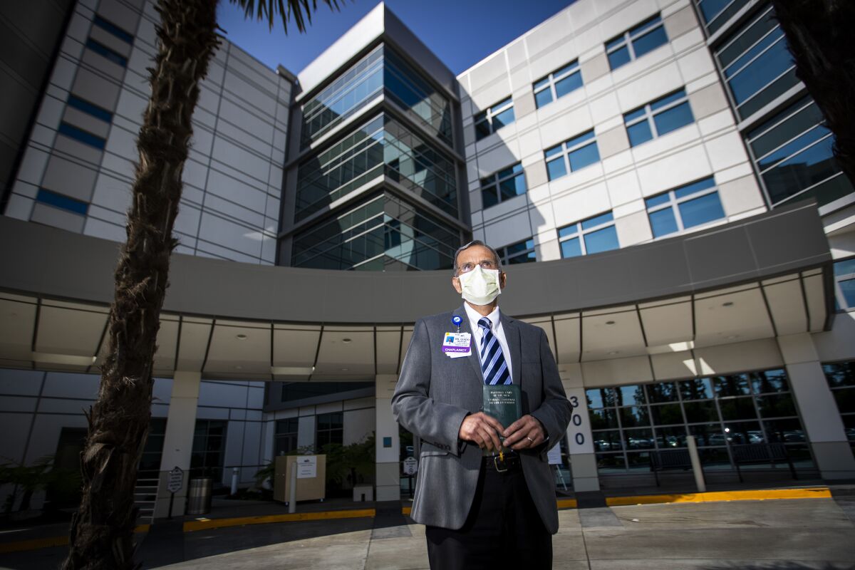 Deacon Guido Zamalloa, chaplain at Methodist Hospital of Southern California, stands in front of the hospital in Arcadia. 