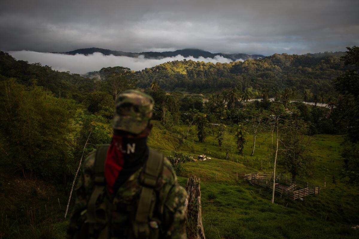 ELN sets up camps in remote locations. A rebel surveys an area that can only be reached by river.