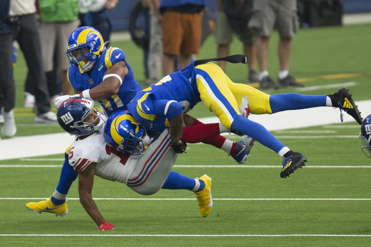 Los Angeles Rams cornerback Jalen Ramsey (20), right, tackles New York Giants wide receiver Golden Tate (15)  