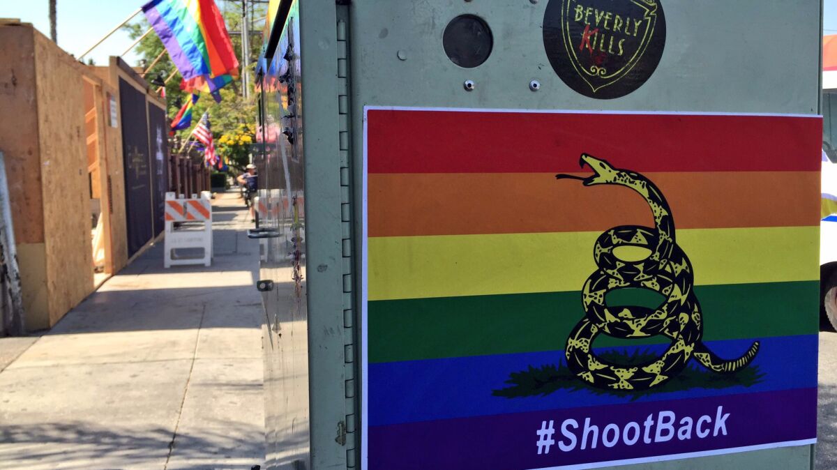 Stickers featuring a rainbow-colored version of the Gadsden flag were hanging near the Abbey Food & Bar, a well-known West Hollywood gay bar, on Thursday morning.