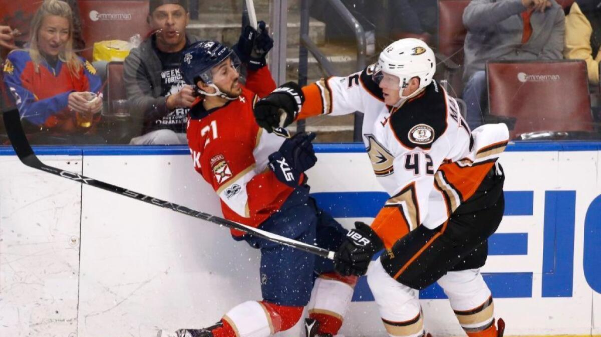 Ducks defenseman Josh Manson slams Panthers center Vincent Trocheck into the boards during the second period of a game in Florida on Feb. 3.