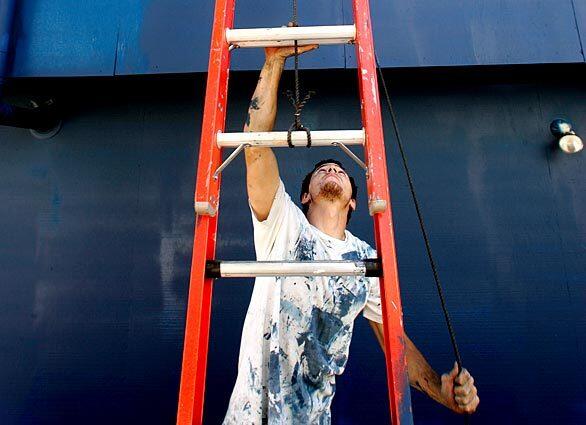 If you're a painter, like Josh Bye, here plying his trade in Santa Monica, it's pretty much impossible to avoid ladders. If you are superstitious, and suffer as well from paraskevidekatriaphobia, you might want to steer clear.