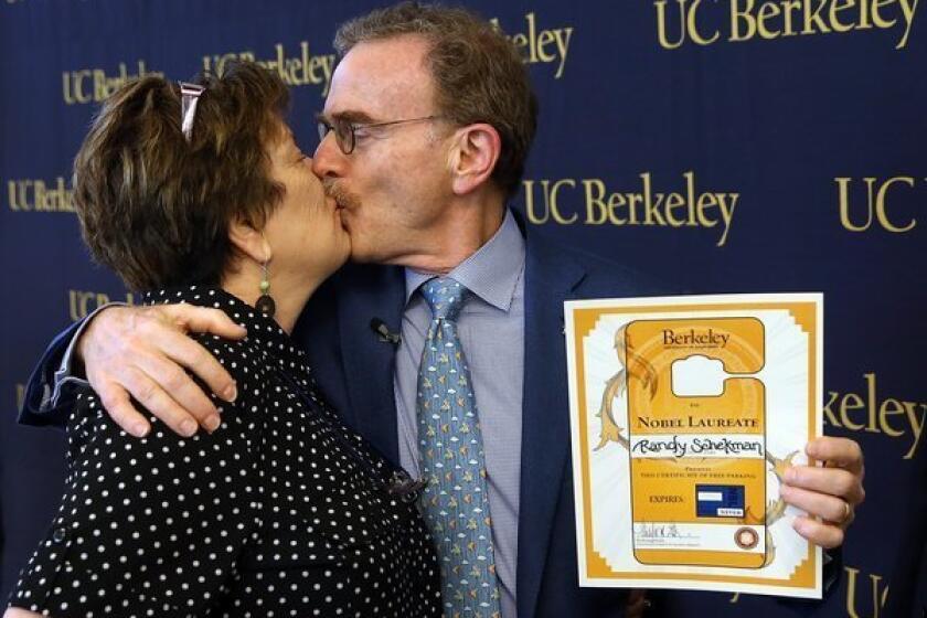 UC Berkeley professor Randy Schekman kisses his wife, Nancy Walls, during a news conference Monday announcing his place among this years recipients of the Nobel Prize in physiology or medicine.