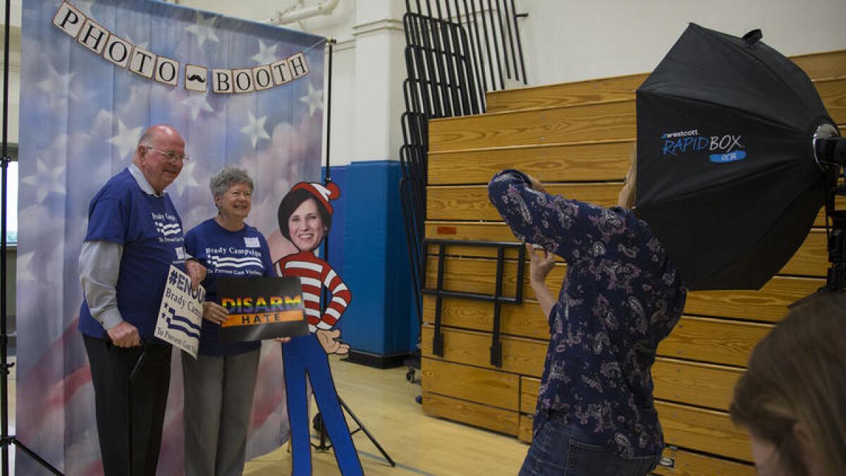 Charlie and Mary Leigh Blek of Trabuco Canyon get their photo taken with a cardboard cutout of Rep. Mimi Walters during a town hall meeting Walters did not attend on May 9 in Irvine.