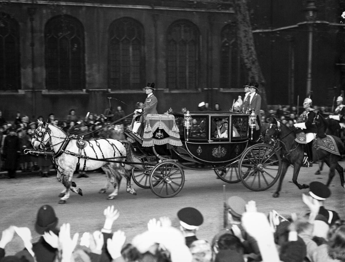 The princess and duke wave to the crowd as they depart Westminster Abbey in the Glass Coach, traditionally used to transport royal brides. Princess Diana would ride in it decades later on the way to her wedding.