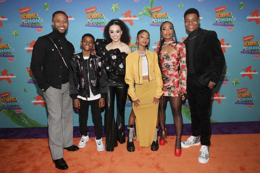 The cast of Nickeoldean's 'That Girl Lay Lay' pose on an orange carpet at the Kids' Choice Awards