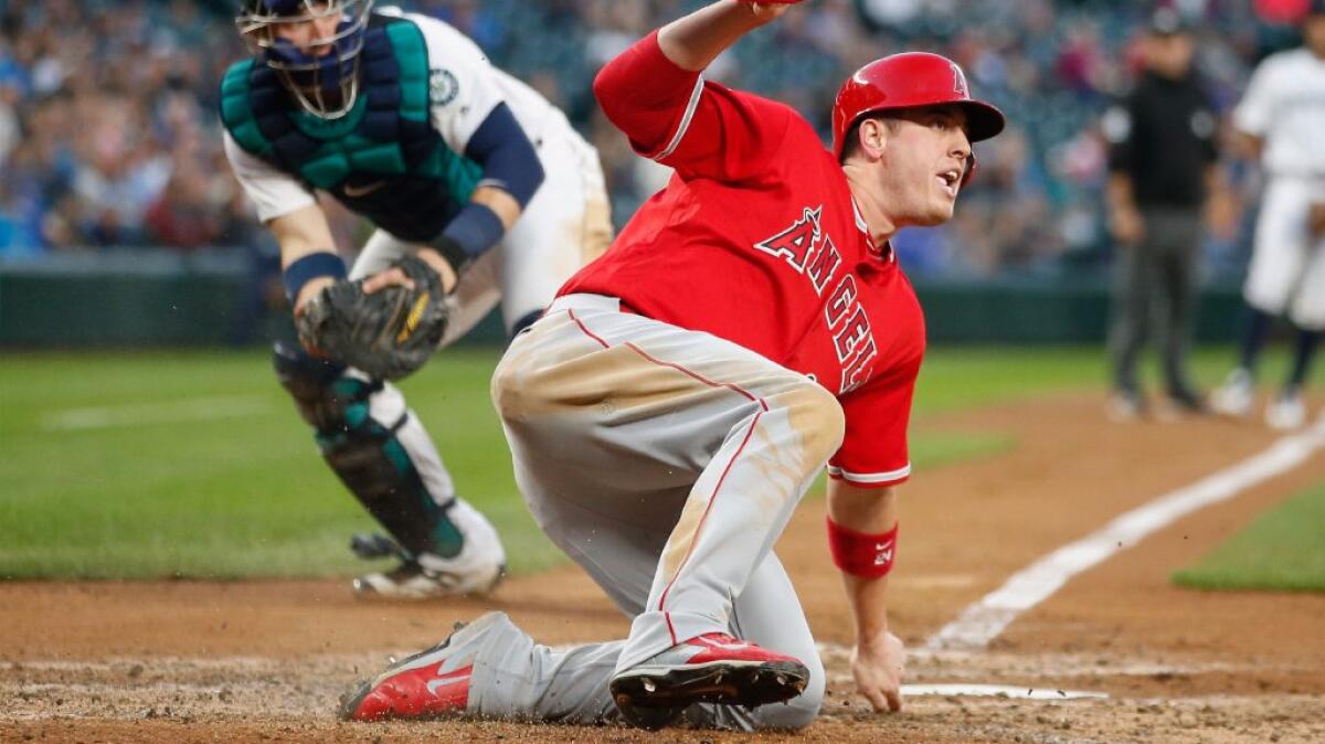 C.J. Cron reacts after scoring in the fourth inning of the Angels' 10-3 win over the Mariners on Sept. 3.
