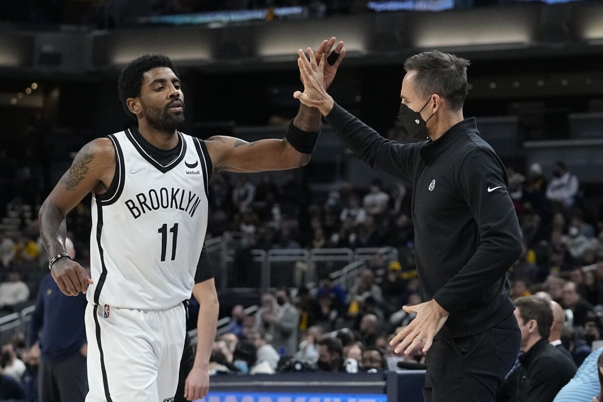 Brooklyn Nets coach Steve Nash reacts with Kyrie Irving during the second half of the team's NBA basketball game against the Indiana Pacers, Wednesday, Jan. 5, 2022, in Indianapolis. (AP Photo/Darron Cummings)