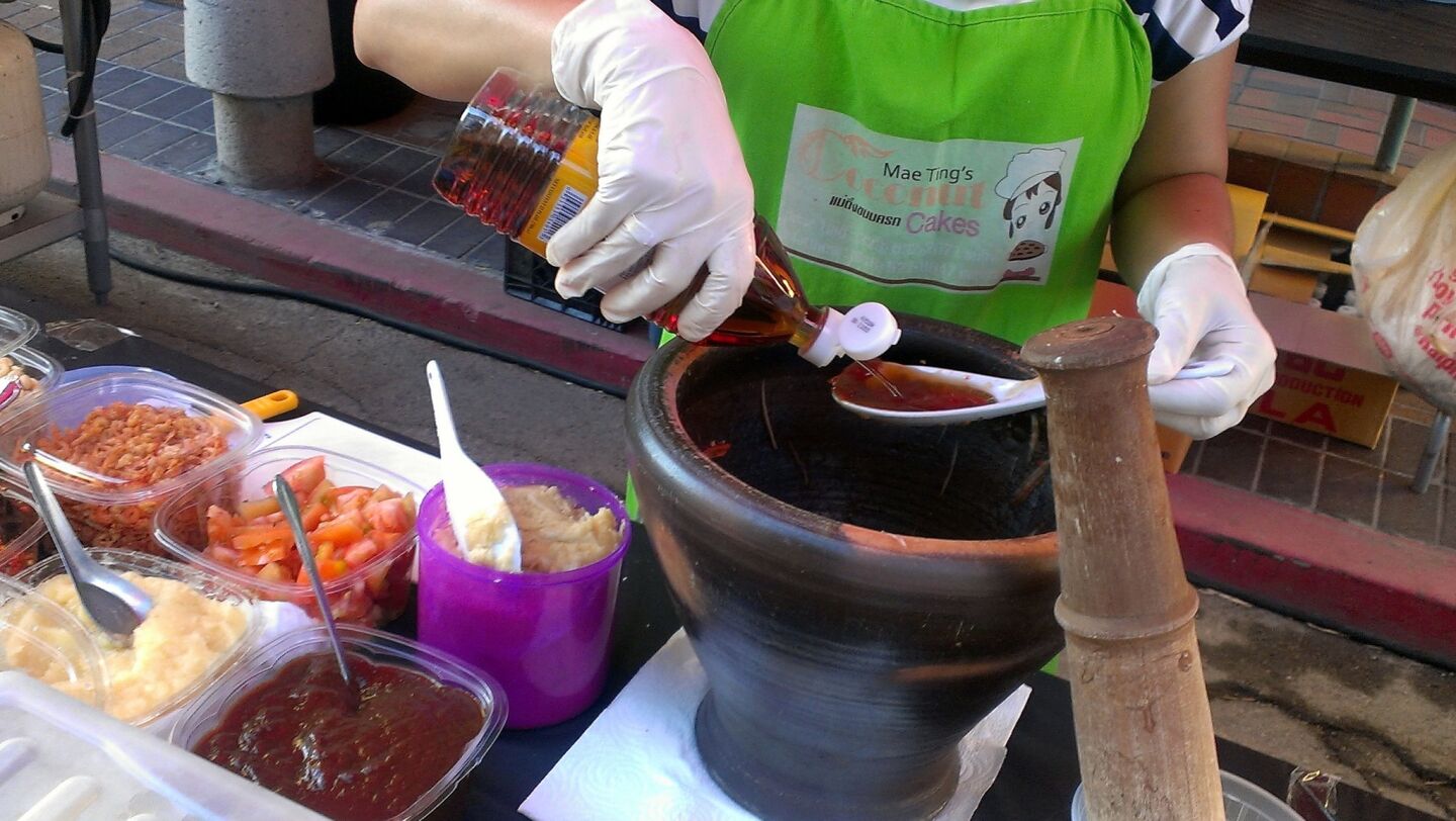 Papaya salad is made fresh with a traditional mortar and pestle.