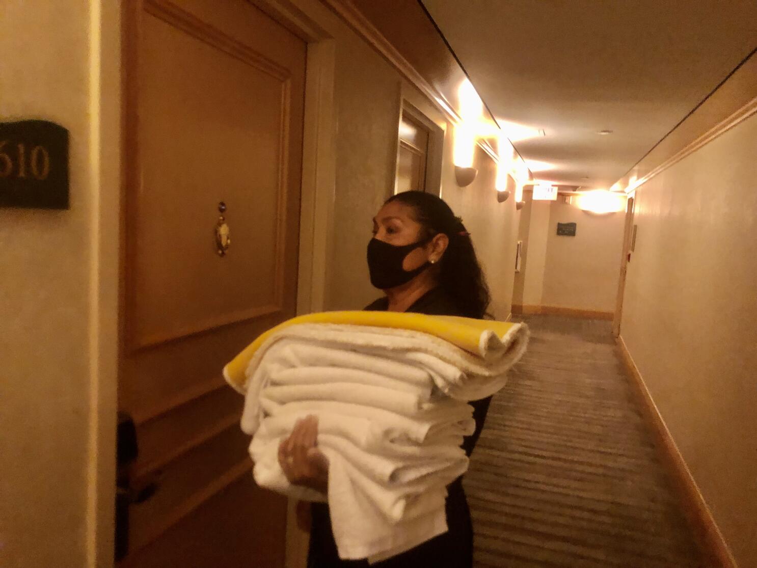 Maid With Fresh Clean Towels During Housekeeping In A Hotel Room
