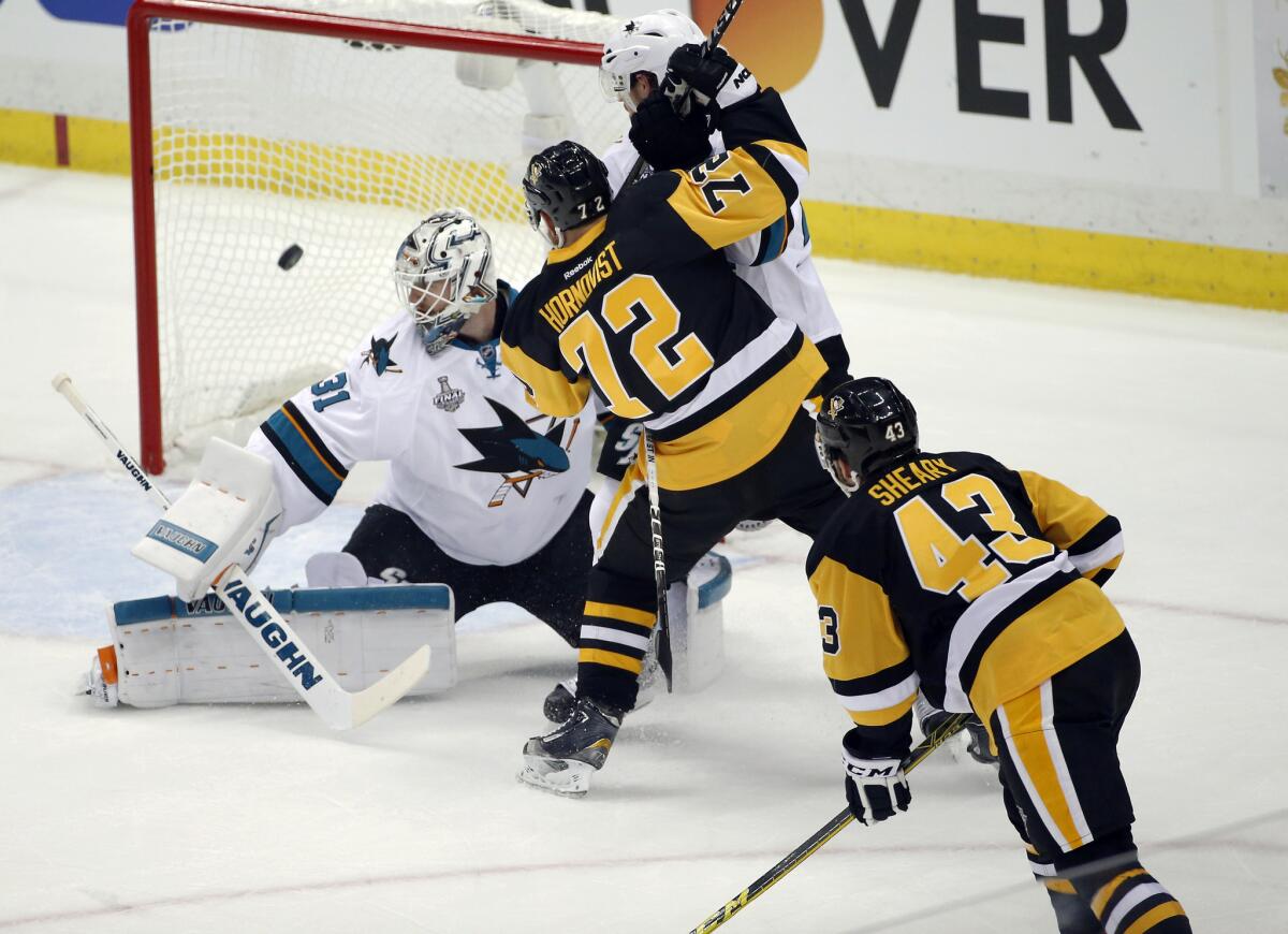 Penguins' Conor Sheary (43) watches his shot sail past Sharks goalie Martin Jones (31) for a goal during the first period in Game 1.