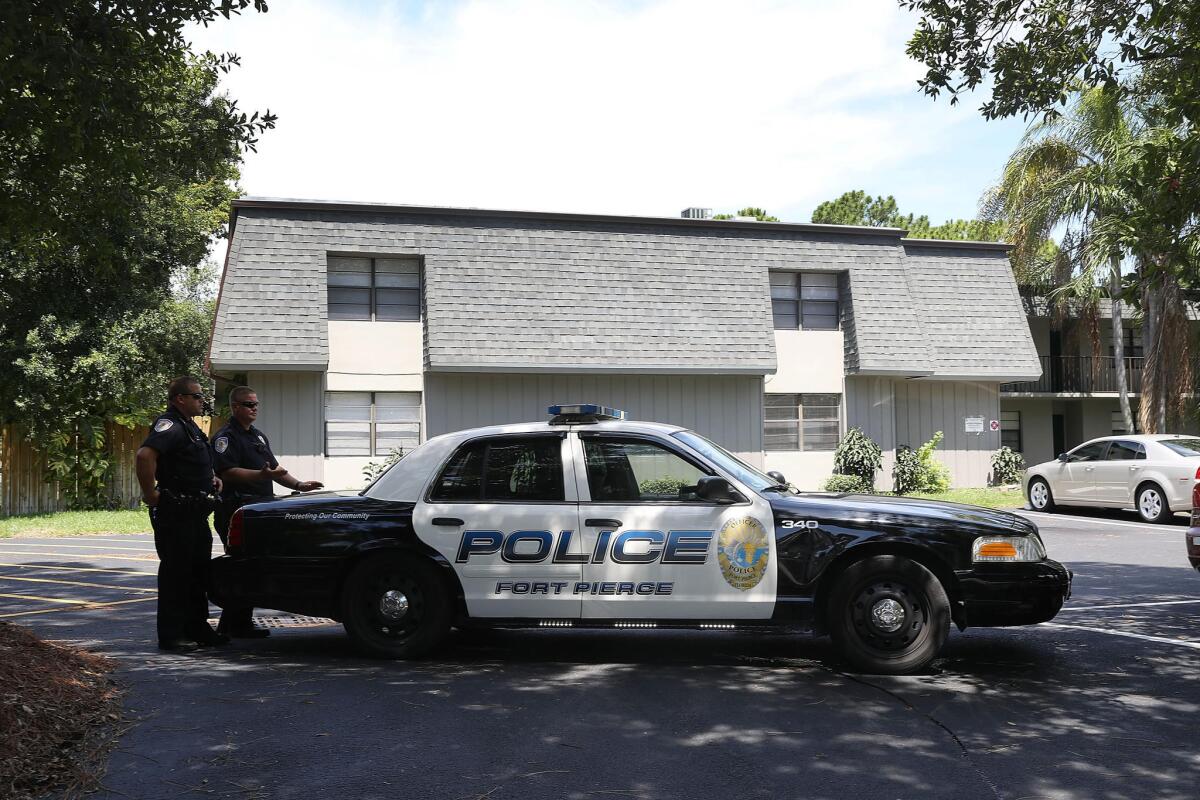 Police outside the apartment complex where the gunman is believed to have lived.