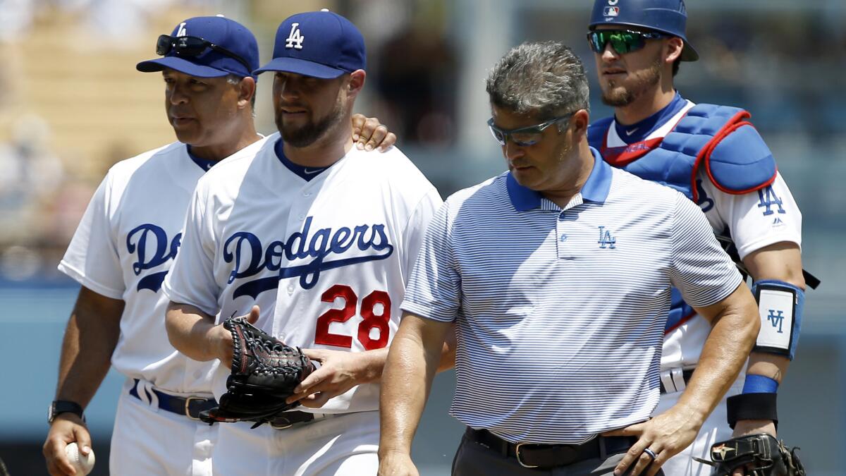 Dodgers starter Bud Norris (28) comes out of the game after injuring his back after recording just one out Sunday.