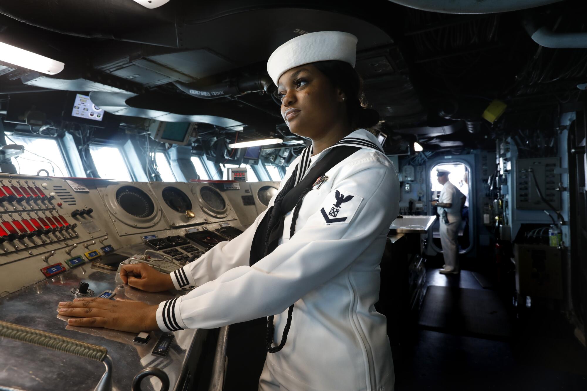 Petty Officer 3rd Class Takelia Latore of Bridgeport, Conn., at the helm of the amphibious assault ship USS Essex