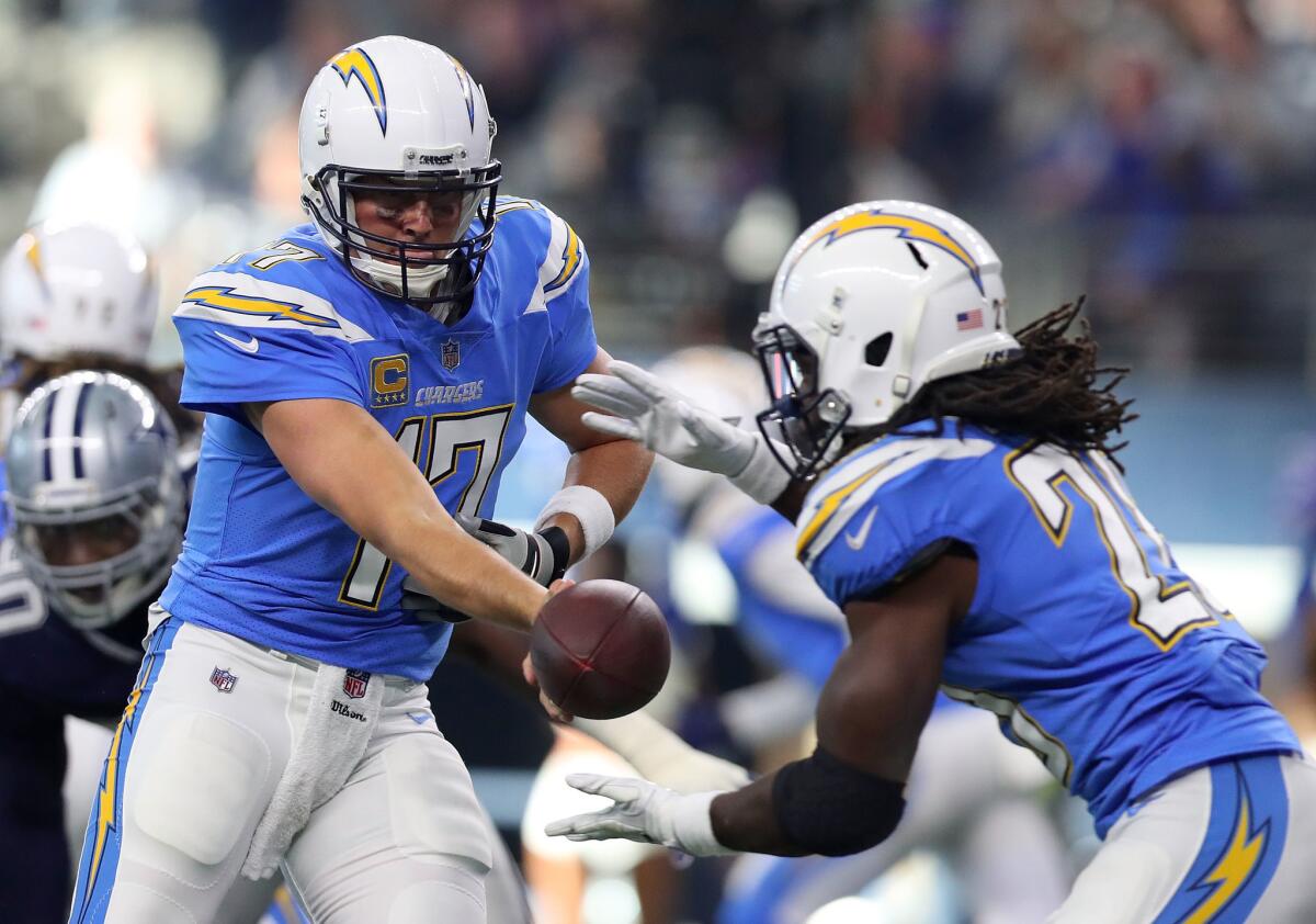 Chargers running back Melvin Gordon takes the handoff from quarterback Philip Rivers during a game against the Cowboys.
