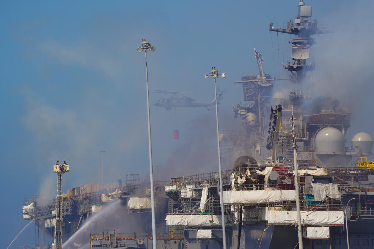 Navy used helicopters for water drops over the fire aboard Bonhomme Richard at San Diego Naval Base on Monday, July 13, 2020.