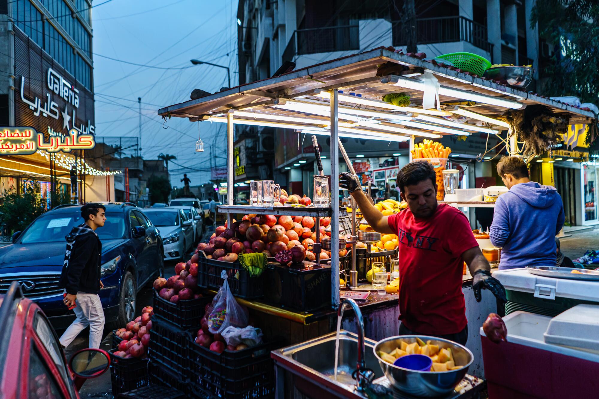 A food vendor near a portable sink at his stand. 