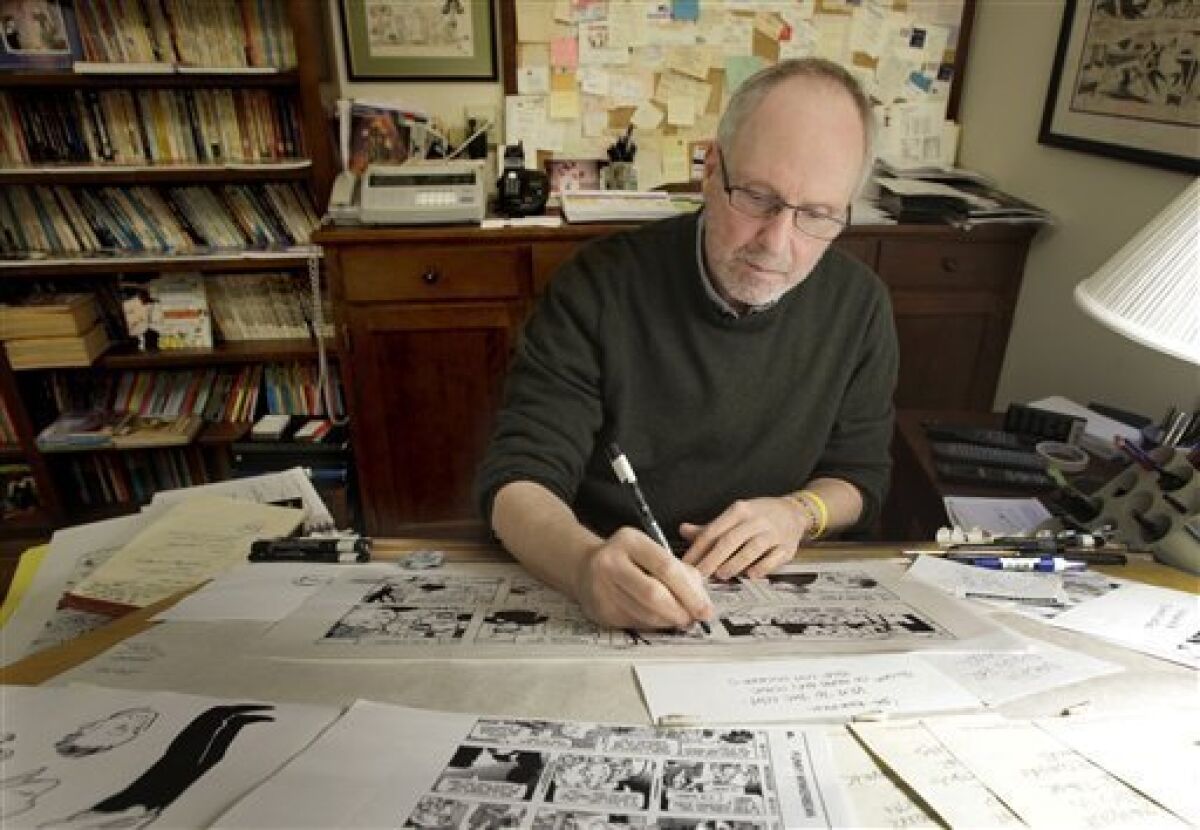 In this April 10, 2012 photo, cartoonist Tom Batiuk, creator of the comic strip Funky Winkerbean, inks a strip at the drawing table of his Medina, Ohio home studio. During its 40-year run on the funny pages, the characters and Batiuk have evolved and so have the story lines, from high school hijinks and awkward teen dating moments to dealing with adult issues like alcoholism, suicide and cancer. His latest hot topic story line during May: two boys who want to go to the high school prom together. (AP Photo/Amy Sancetta)