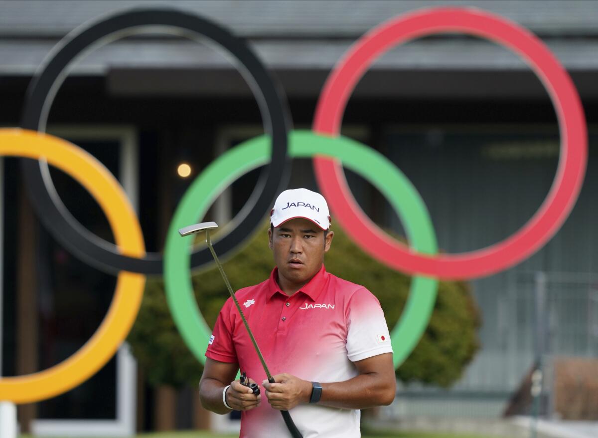 Hideki Matsuyama holds a golf club at the Tokyo Olympics.