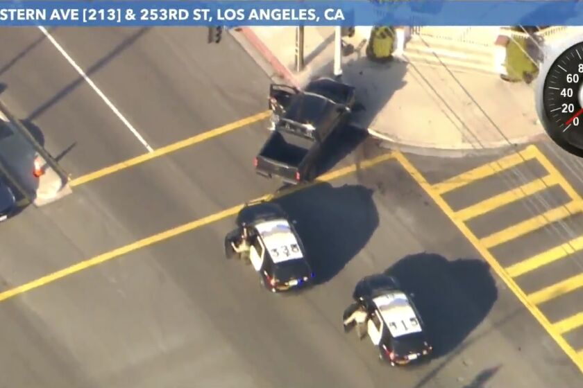 Law enforcement officials chase a suspect after a wild pursuit Friday afternoon in the streets of Los Angeles.(KTLA-TV)
