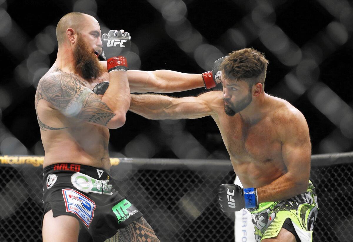 Andrei Arlovski, right, and Travis Browne trade blows during their heavyweight, mixed-martial arts bout at UFC 187 on Saturday, May 23, 2015, in Las Vegas.
