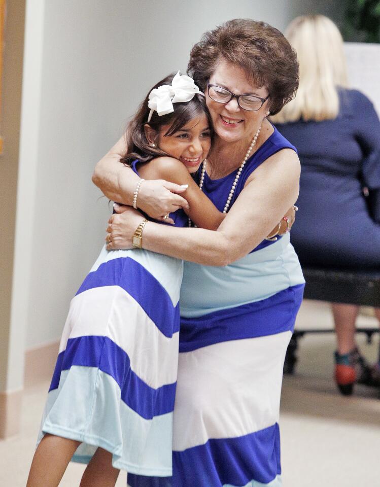 Alice Petrossian hugs her granddaughter Katherine Mina at a fundraiser fashion show featuring grandparents with their grand children at Adventist Health Center in Glendale on Thursday, September 6, 2018. The goal of the fundraiser was $9,000, but when all was counted, they raised over $12,000 for the Children's Center â€“ Adventist Health Glendale.