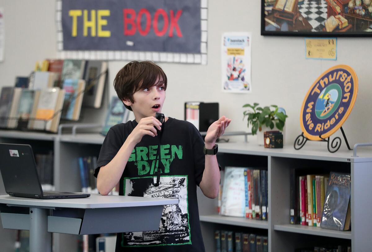 A Thurston seventh-grader presents findings in a stormwater pollution study to city and school staff on Tuesday.