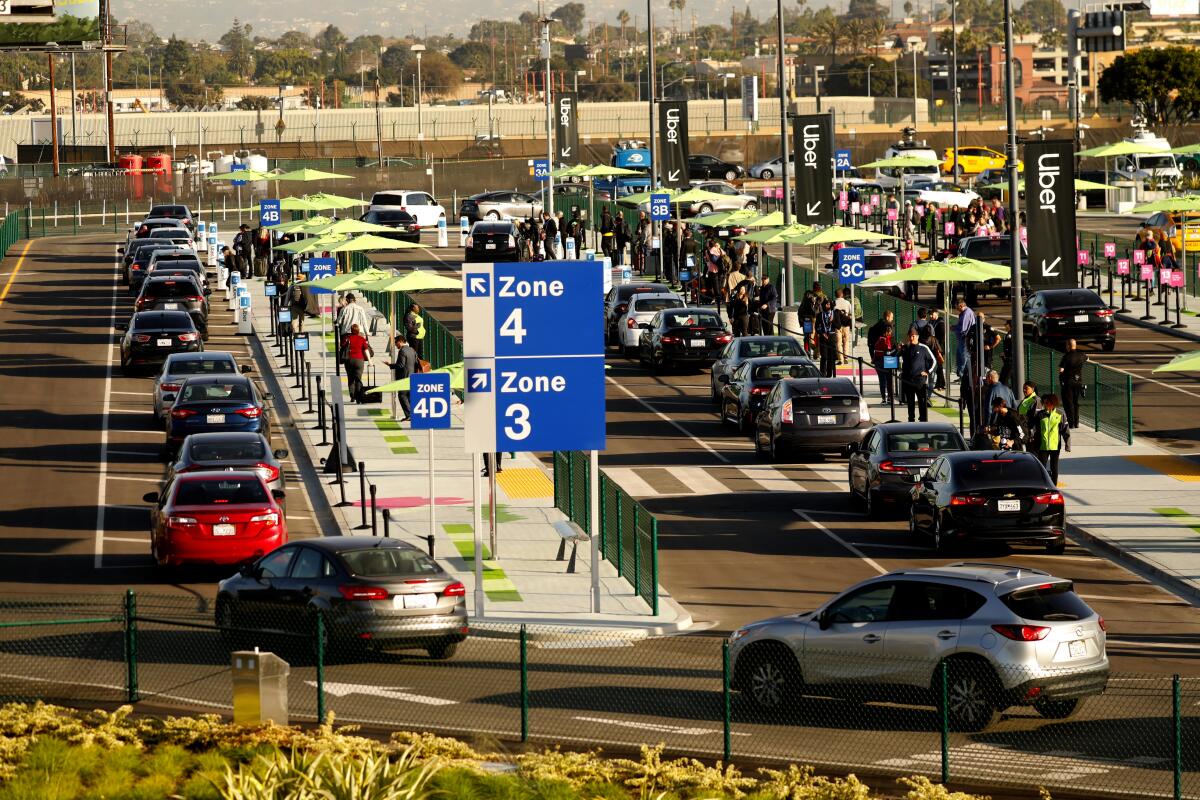 Rideshare and taxi vehicles pick up passengers at L.A. International Airport on Oct. 29, the first day of operation for the new LAXit lot.